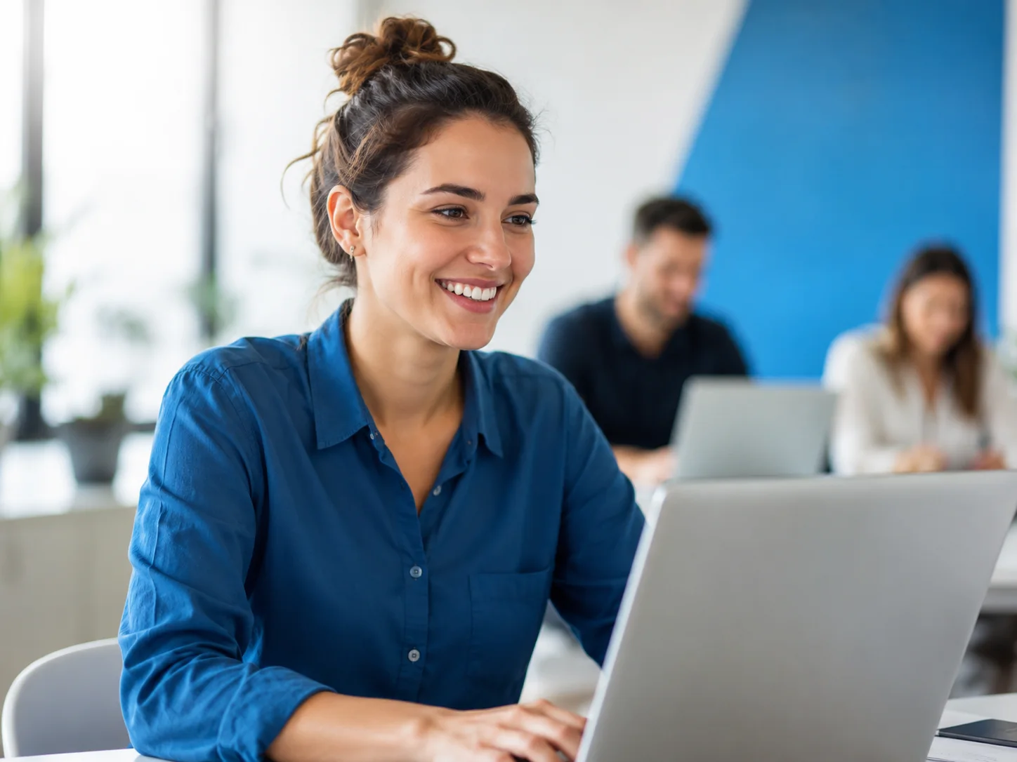 Apprenante en formation digitale avec ordinateur portable dans un environnement de travail moderne
